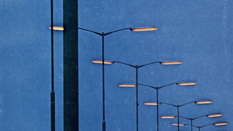 The cover of The Speaking Clock’s Sodium Yellow Night LP, which features a blue evening sky and street lights