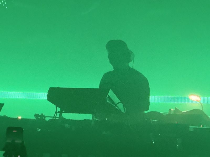 Jeff Mills DJing at SWG3, surrounded by green light